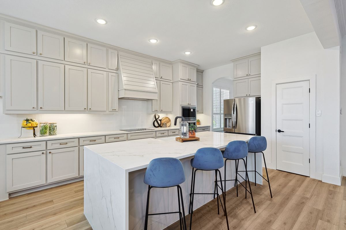 Wide view of renovated kitchen and island