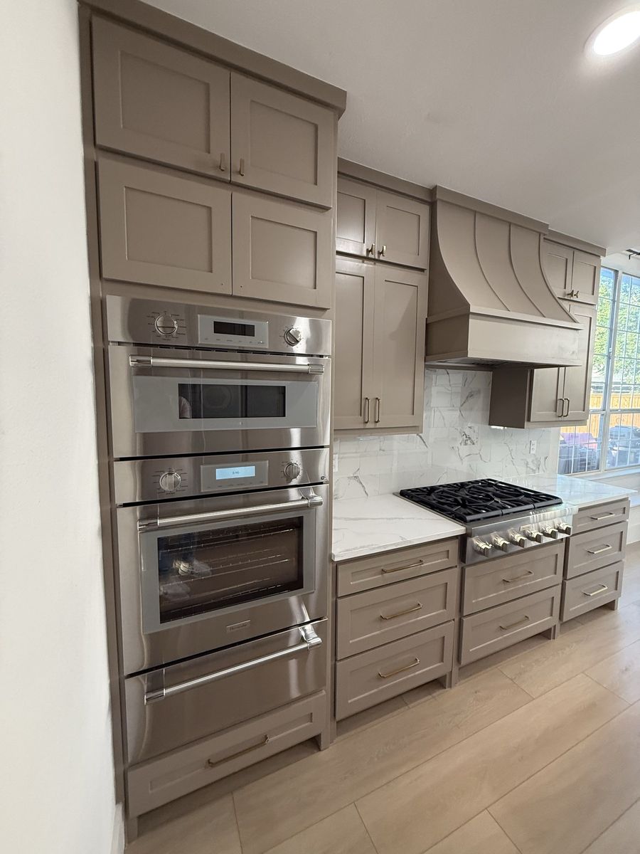 Gas range, double ovens and marble slab backsplash
