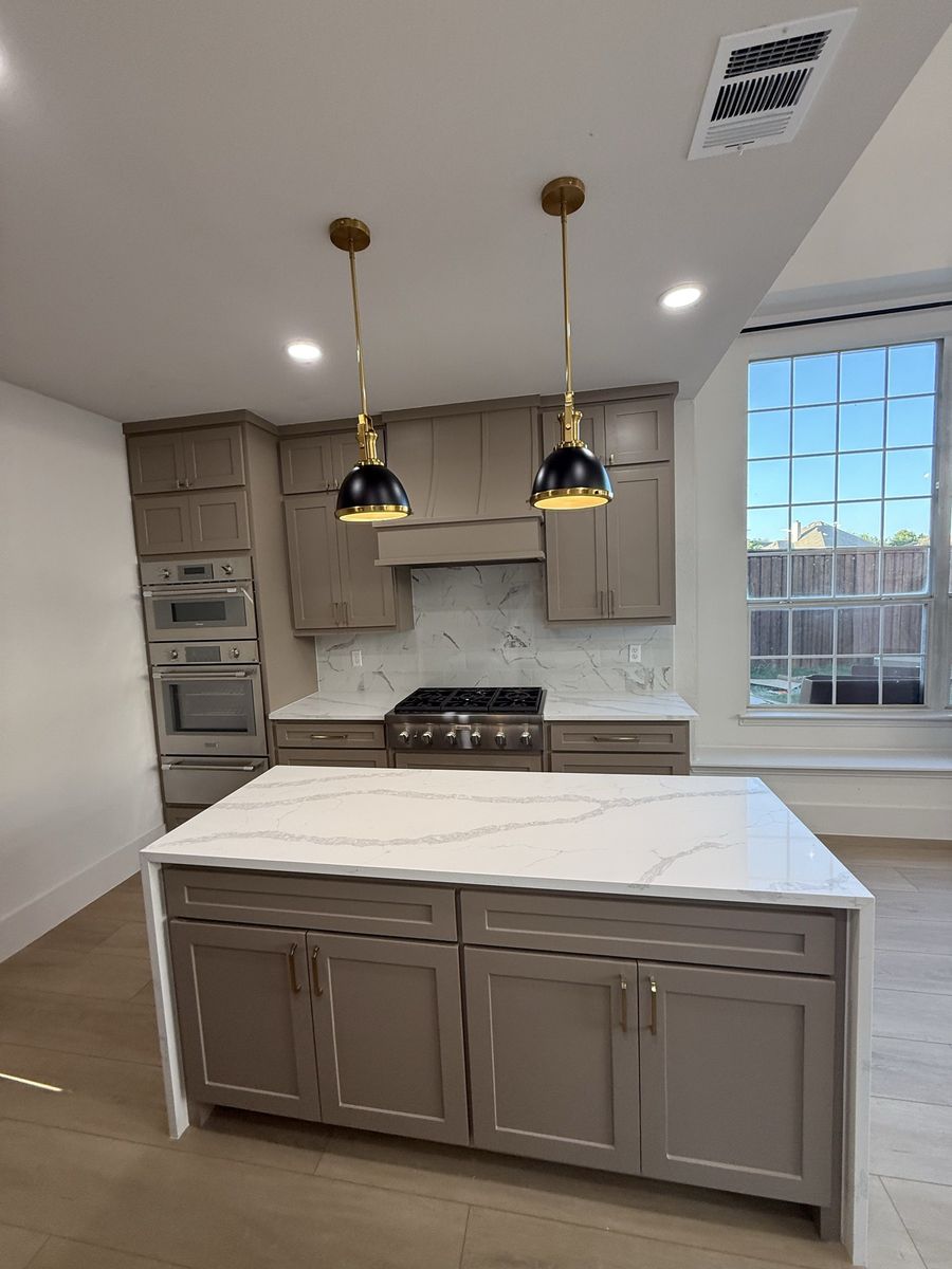 Kitchen island with brass pendant lighting