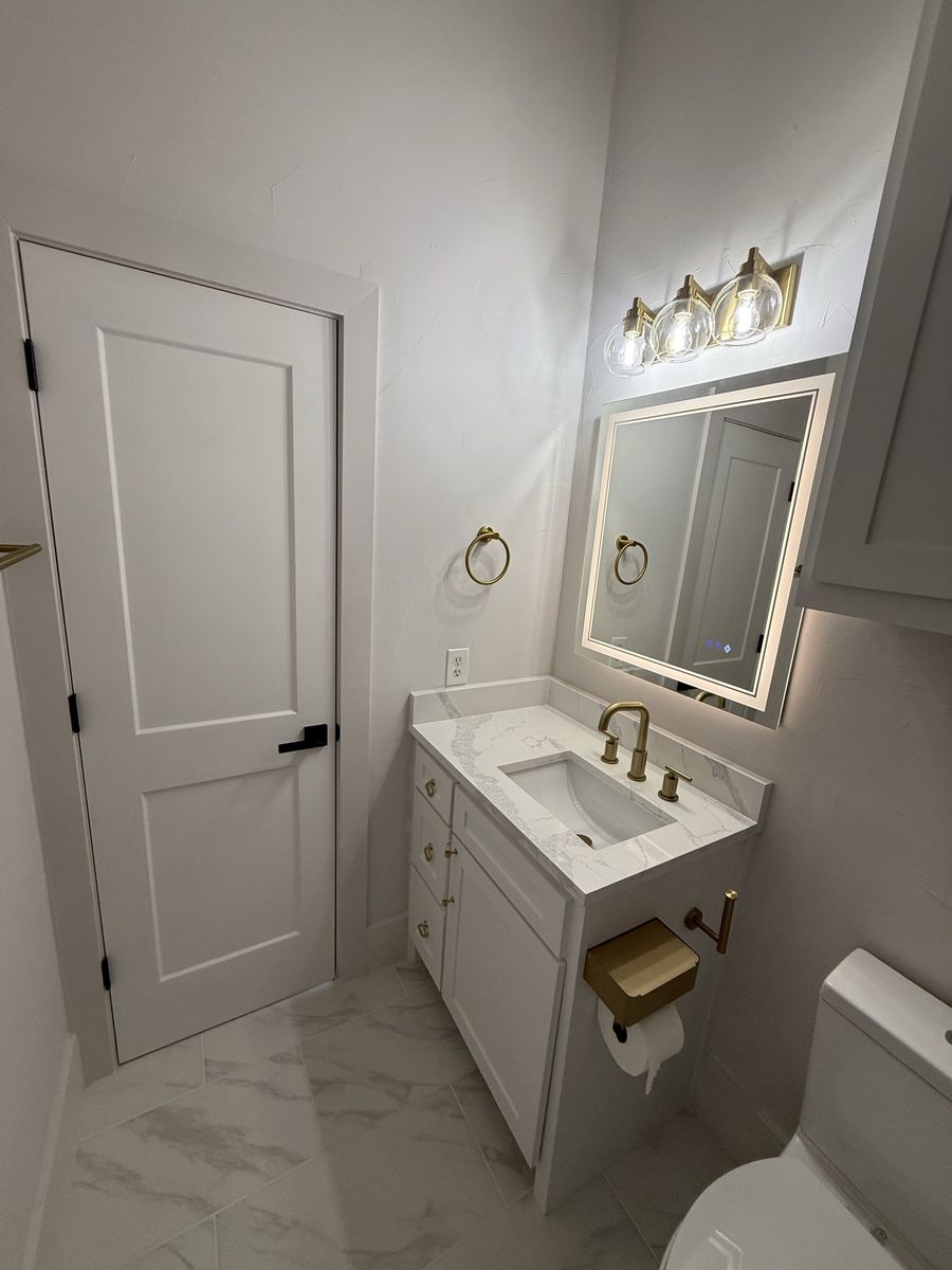 Marble tub surround with brass fixtures