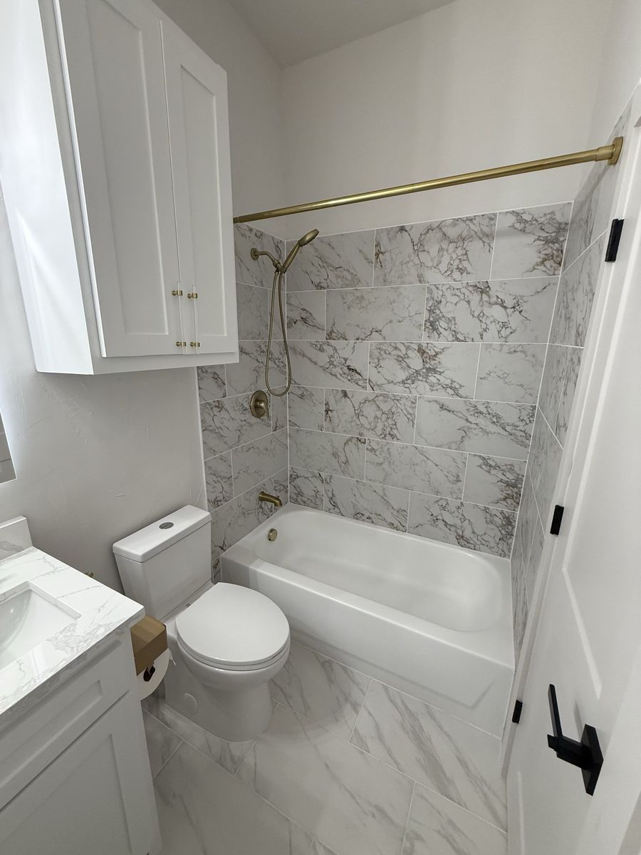 Vanity with brass tapware and lit mirror