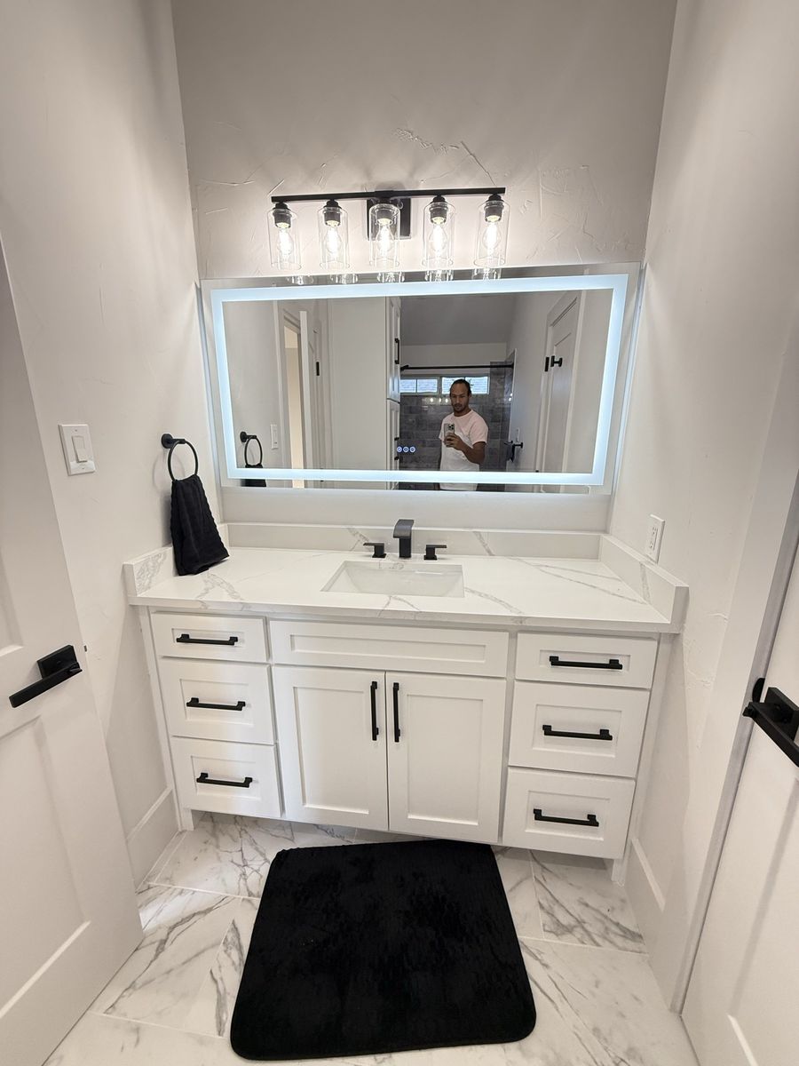 Guest bath with stacked tile and white vanity