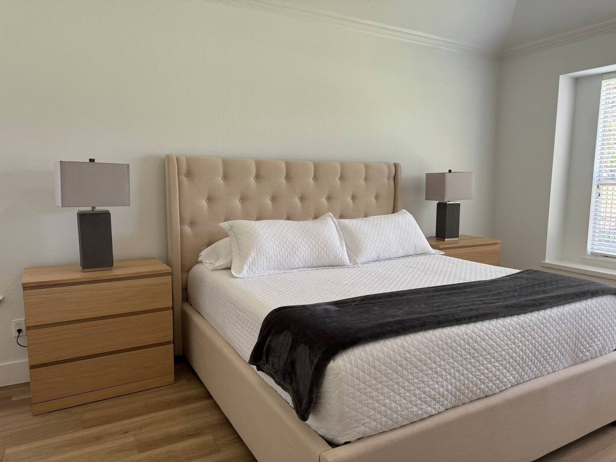 Primary bedroom with wide-plank flooring