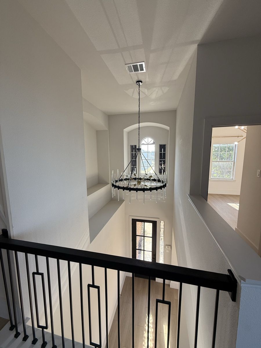 Two-storey stair hall with chandelier
