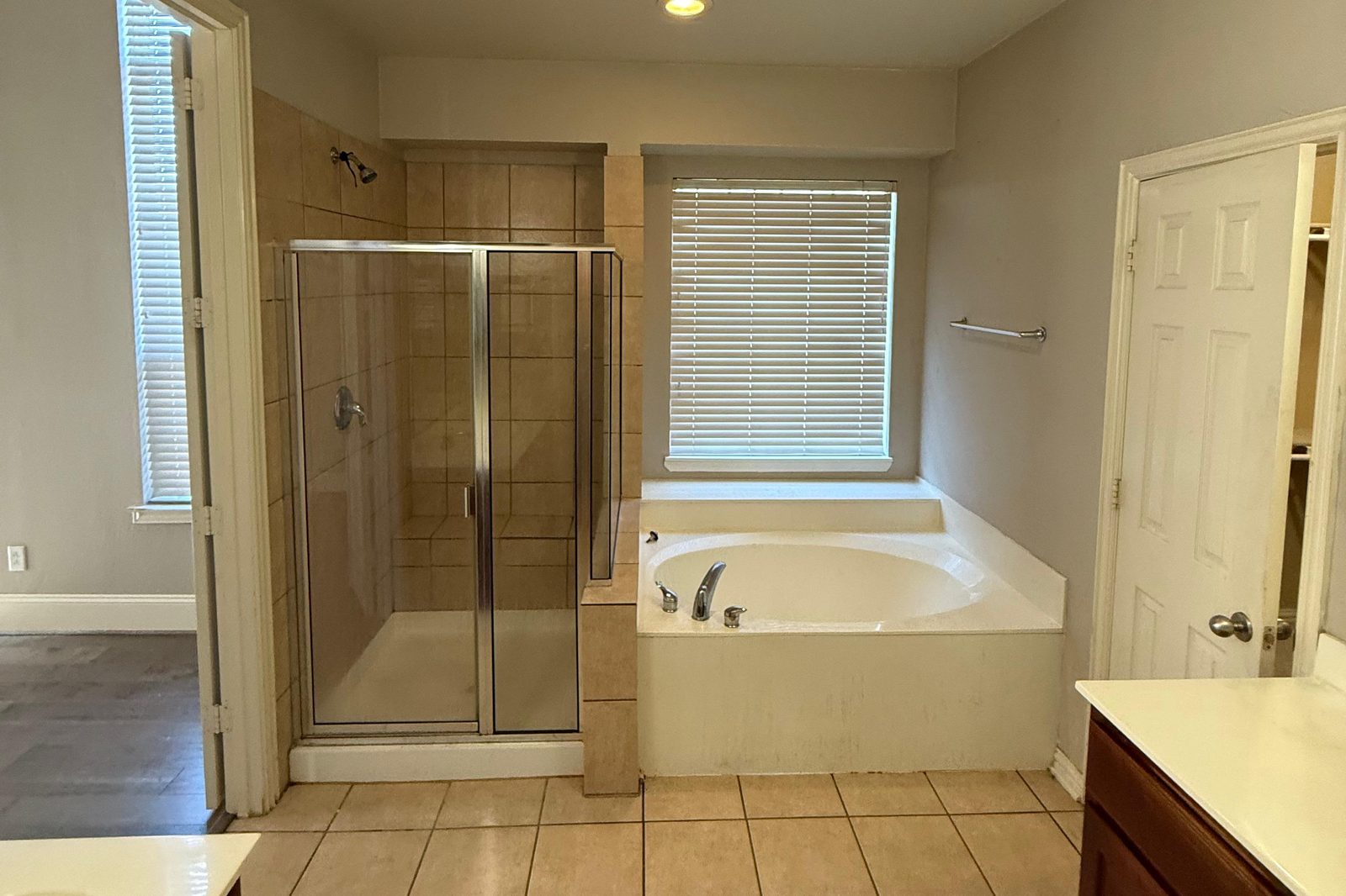 Original primary bath with beige tile and corner garden tub