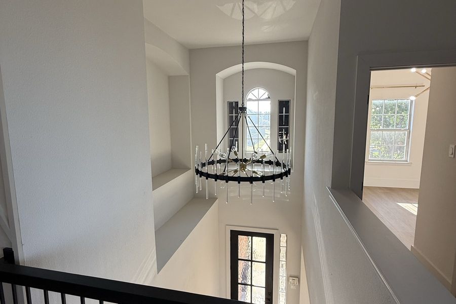 Two-storey stair hall with chandelier